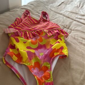 Yellow, orange, pink and green bathing suit for a little kid 24 months